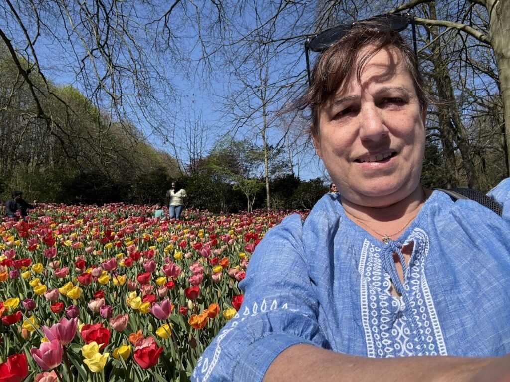 Woman in blue shirt among tulips in Floralia Brussels